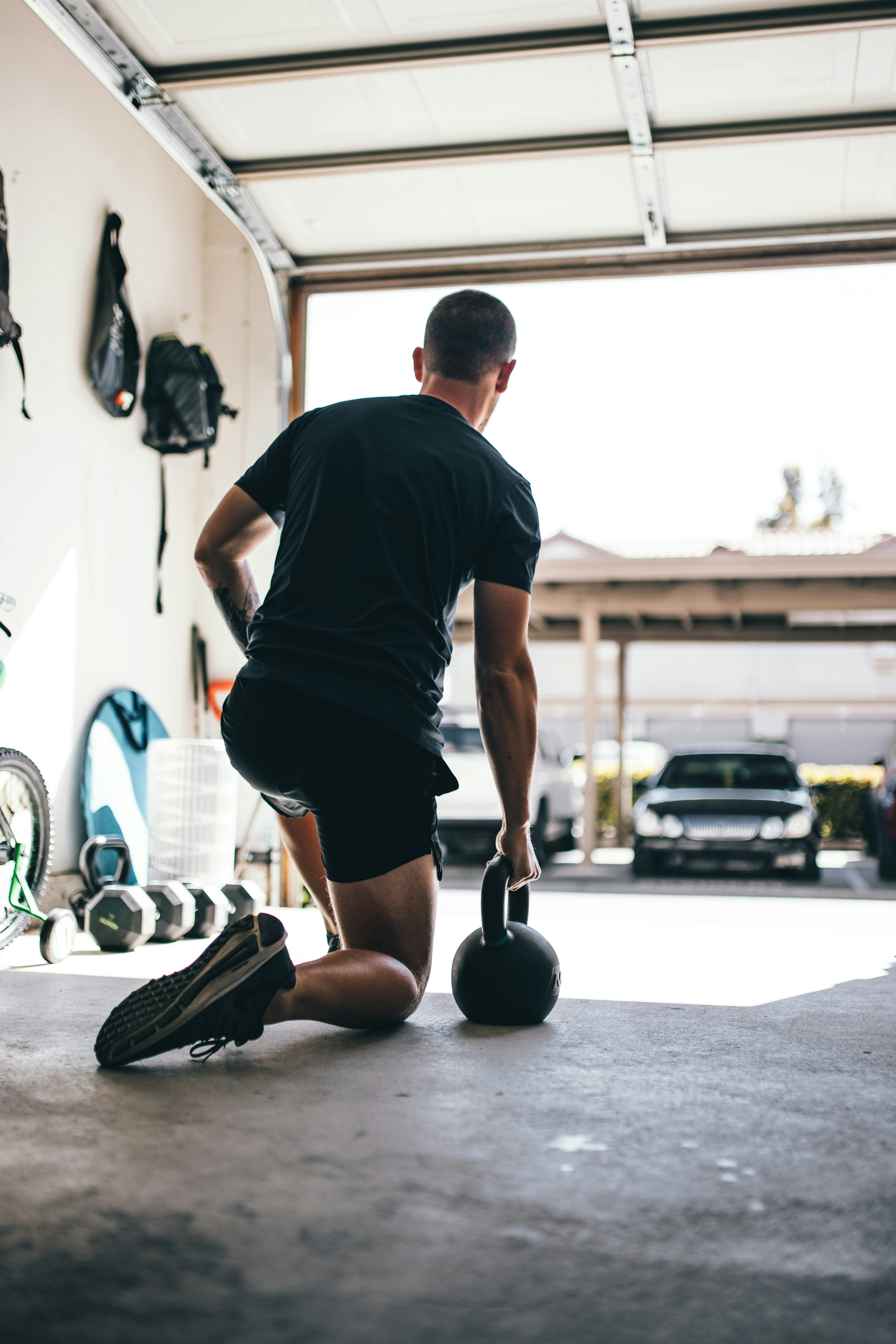Athlete training with kettlebell in garage gym